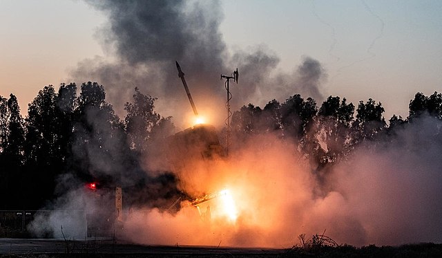 Missiles being fired against a darkening sky