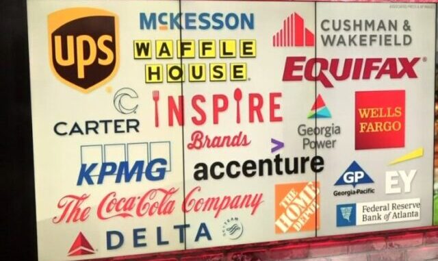 Board showing logos of various corporations, such as Equifax and Wells Fargo, invested in the construction of Cop City.