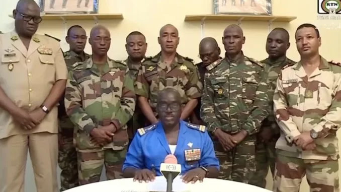 Niger army spokesman Colonel-Major Amadou Abdramane speaks on behalf of General Tchiani during an appearance on national television, after President Mohamed Bazoum was held in the presidential palace in Niamey, Niger, July 26, 2023 [ORTN via Reuters TV]