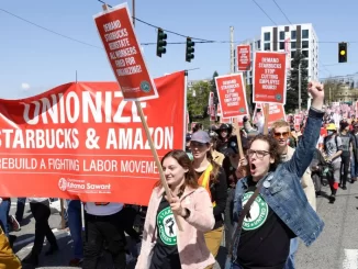 People march during the "Fight Starbucks' Union Busting" rally and march in Seattle, Wash., on April 23, 2022. Jason Redmond/AFP—Getty Images