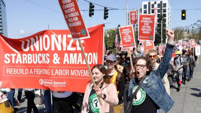 People march during the "Fight Starbucks' Union Busting" rally and march in Seattle, Wash., on April 23, 2022. Jason Redmond/AFP—Getty Images