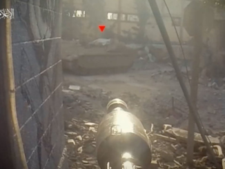 Still image of a first-person view of an RPG pointed at a tank which has the red triangle mark placed over it