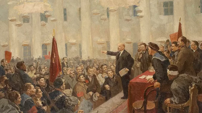 A painting in the soviet realist style depicting Lenin on the right side of the image standing on a rostrum in the winter palace with hand outstretched, speaking to a large assembly