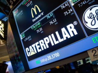 New York Stock Exchange screen prominently featuring the Caterpillar logo and stock info, along with GE and McDonalds