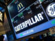 New York Stock Exchange screen prominently featuring the Caterpillar logo and stock info, along with GE and McDonalds