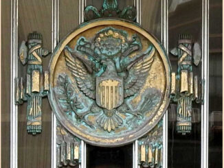 A large wall hanging of the US's official eagle seal surrounded on both sides by Roman fascia, a famous symbol of fascism